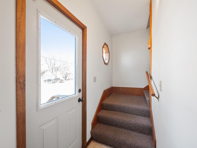 doorway with baseboards and stairs