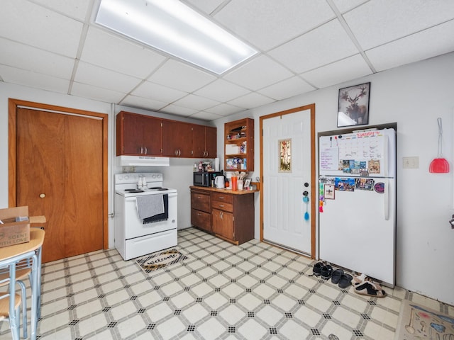 kitchen with open shelves, white appliances, light floors, under cabinet range hood, and a paneled ceiling