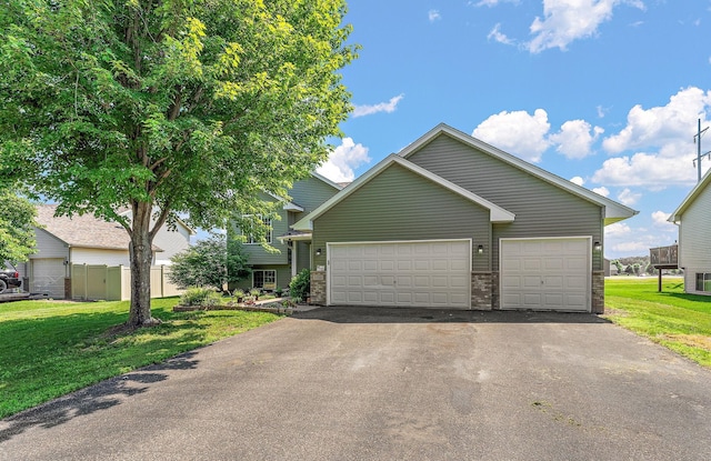 1106 Maplewood Ave SW, Isanti, MN 55040 - view of front facade featuring driveway and an attached garage