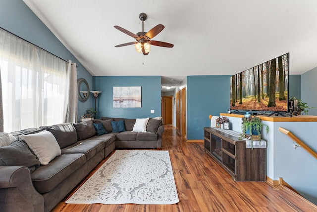 1106 Maplewood Ave SW, Isanti, MN 55040 - living area with vaulted ceiling, a ceiling fan, and wood finished floors