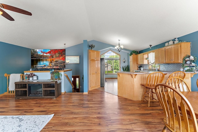 1106 Maplewood Ave SW, Isanti, MN 55040 - kitchen with lofted ceiling, wood finished floors, a chandelier, ceiling fan, and a peninsula