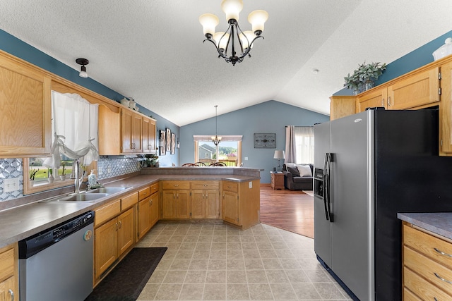 1106 Maplewood Ave SW, Isanti, MN 55040 - kitchen featuring refrigerator with ice dispenser, stainless steel dishwasher, a chandelier, lofted ceiling, and a peninsula