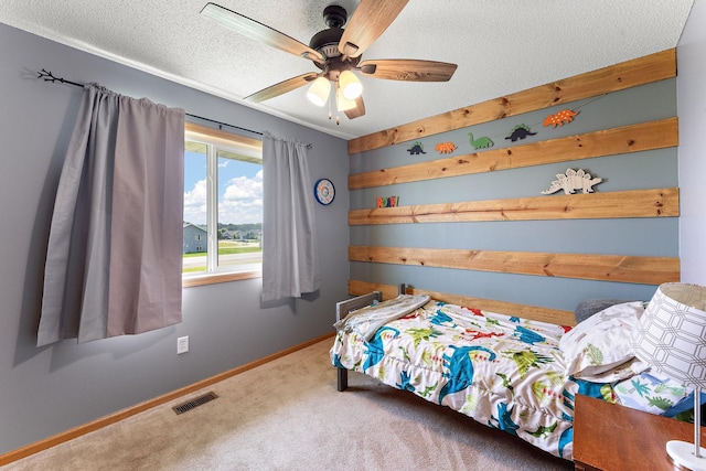 1106 Maplewood Ave SW, Isanti, MN 55040 - bedroom featuring carpet floors, a textured ceiling, and a ceiling fan