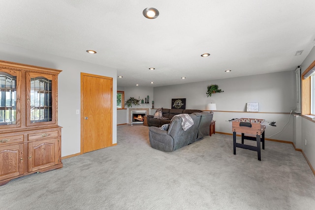 1106 Maplewood Ave SW, Isanti, MN 55040 - living room with light colored carpet, recessed lighting, and a tile fireplace
