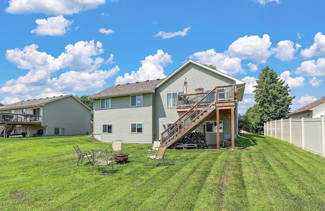 1106 Maplewood Ave SW, Isanti, MN 55040 - rear view of house featuring stairs, a wooden deck, and a fire pit
