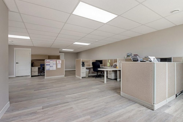 home office featuring baseboards, wood finished floors, and a paneled ceiling