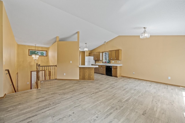 17813 224th Ave NW, Big Lake, MN 55309 - unfurnished living room featuring a chandelier, light wood-type flooring, lofted ceiling, baseboards, and a sink