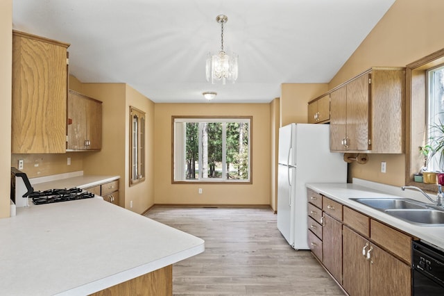 17813 224th Ave NW, Big Lake, MN 55309 - kitchen with a sink, light countertops, black dishwasher, light wood-style floors, and a chandelier