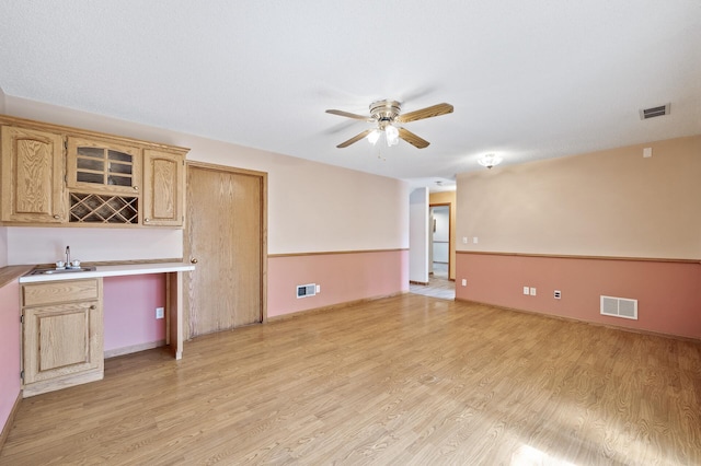 17813 224th Ave NW, Big Lake, MN 55309 - unfurnished living room featuring light wood finished floors, a ceiling fan, wet bar, and baseboards