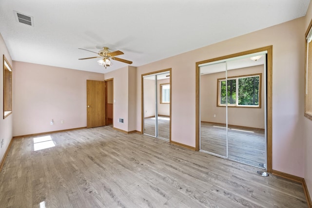 17813 224th Ave NW, Big Lake, MN 55309 - unfurnished bedroom with two closets, light wood finished floors, baseboards, and ceiling fan