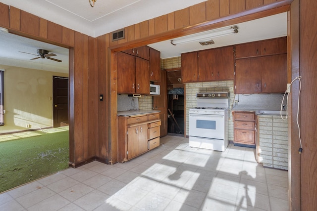 123 Thomas Hill Rd, Jackson, MN 56143 - kitchen with brown cabinets, light countertops, visible vents, white appliances, and decorative backsplash