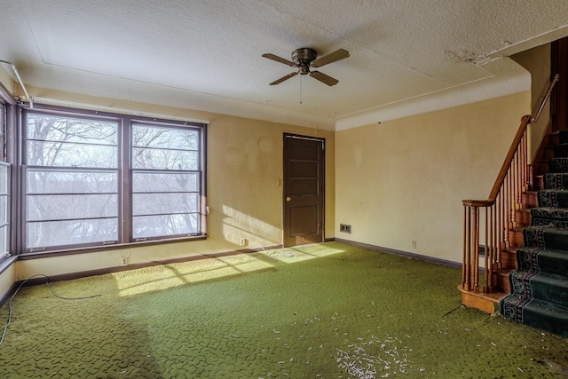 123 Thomas Hill Rd, Jackson, MN 56143 - carpeted spare room featuring baseboards, stairway, a textured ceiling, and ceiling fan