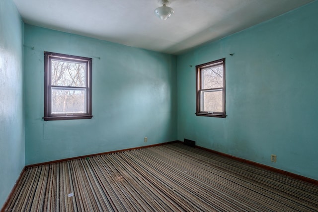 123 Thomas Hill Rd, Jackson, MN 56143 - carpeted empty room featuring a healthy amount of sunlight, baseboards, and visible vents