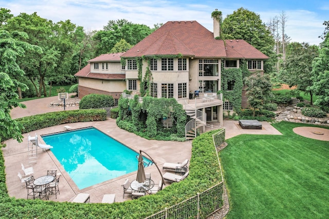 4325 Trillium Ln W, Minnetrista, MN 55364 - view of swimming pool featuring stairs, a patio, a deck, a diving board, and view of scattered trees