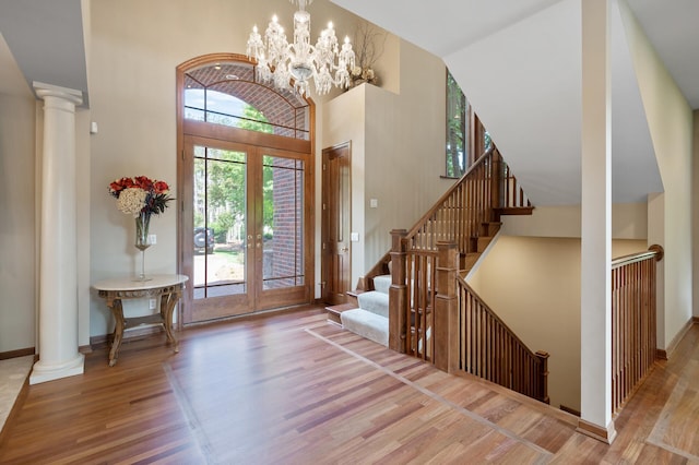 4325 Trillium Ln W, Minnetrista, MN 55364 - foyer entrance with wood finished floors, a towering ceiling, healthy amount of natural light, and french doors