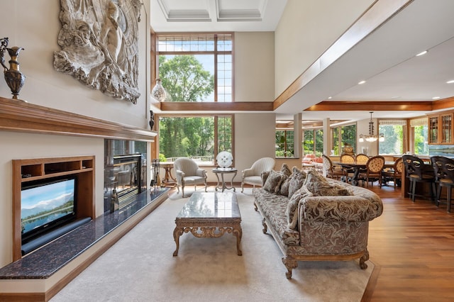 4325 Trillium Ln W, Minnetrista, MN 55364 - living room featuring a high ceiling, a fireplace, wood finished floors, recessed lighting, and a chandelier