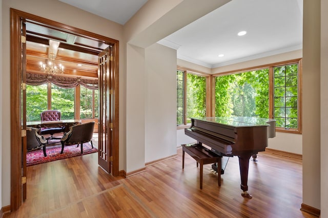 4325 Trillium Ln W, Minnetrista, MN 55364 - living area with light wood finished floors, a chandelier, and crown molding