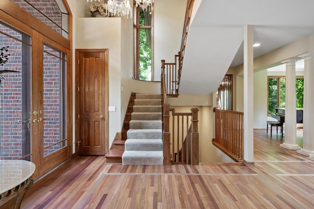 4325 Trillium Ln W, Minnetrista, MN 55364 - foyer with wood finished floors, ornate columns, stairway, a chandelier, and recessed lighting