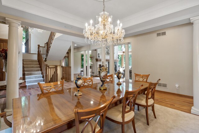 4325 Trillium Ln W, Minnetrista, MN 55364 - dining space featuring light wood finished floors, ornate columns, stairs, and a chandelier