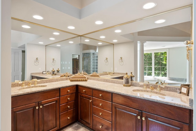 4325 Trillium Ln W, Minnetrista, MN 55364 - full bath with double vanity, recessed lighting, and decorative columns