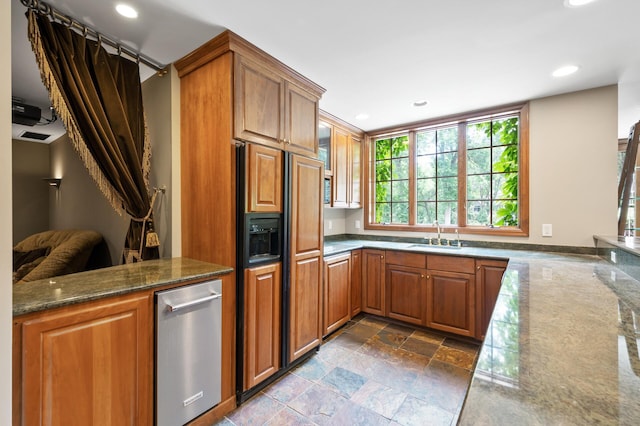 4325 Trillium Ln W, Minnetrista, MN 55364 - kitchen with paneled fridge, brown cabinets, recessed lighting, and stone tile flooring