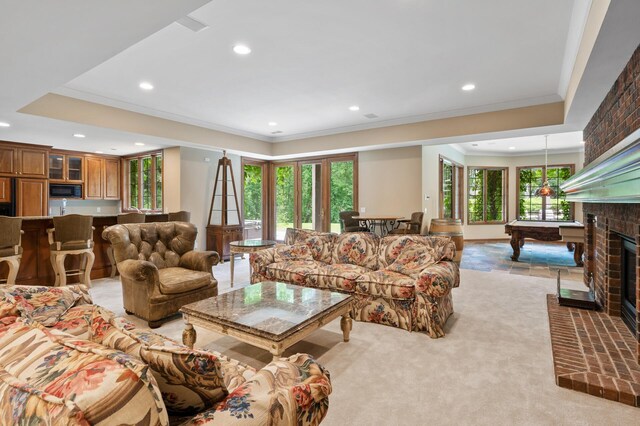 4325 Trillium Ln W, Minnetrista, MN 55364 - living area featuring ornamental molding, recessed lighting, a brick fireplace, light colored carpet, and a raised ceiling