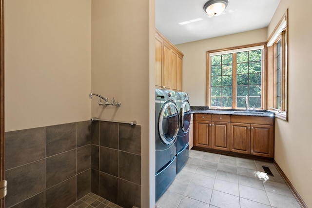 4325 Trillium Ln W, Minnetrista, MN 55364 - laundry area with washer and clothes dryer, light tile patterned floors, and cabinet space