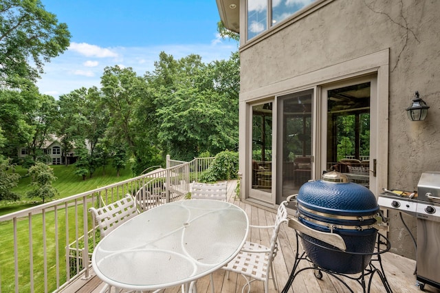 4325 Trillium Ln W, Minnetrista, MN 55364 - wooden deck featuring a grill, a lawn, view of scattered trees, and outdoor dining space