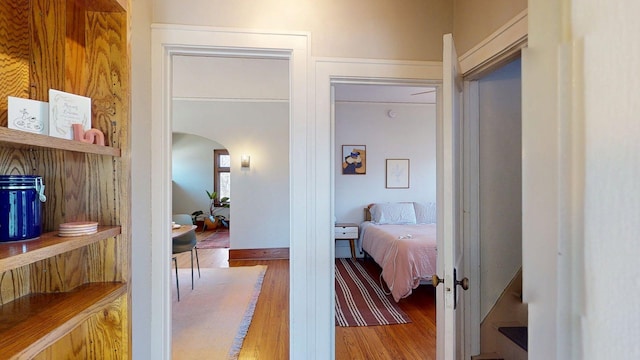 interior space featuring arched walkways and wood finished floors