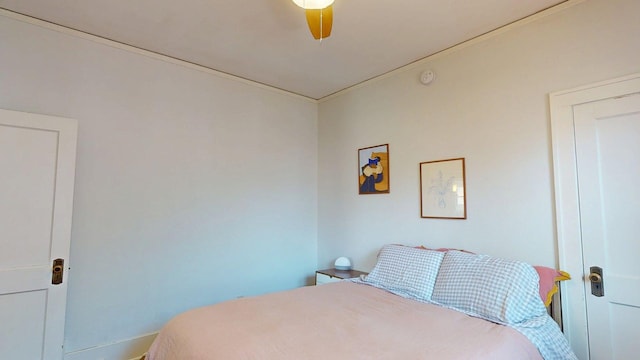 bedroom featuring baseboards and a ceiling fan