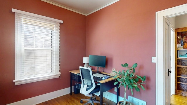 office with baseboards, ornamental molding, and wood finished floors