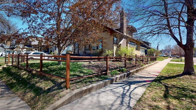 view of community featuring fence and a residential view