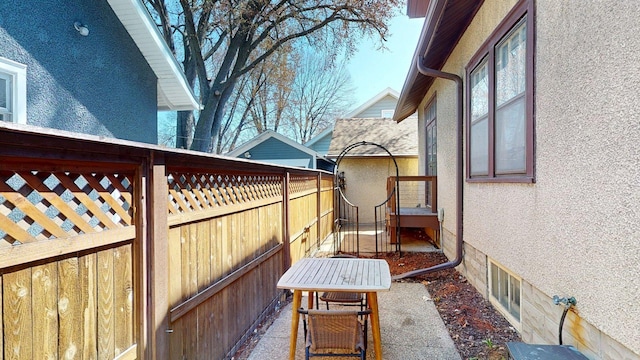 exterior space featuring stucco siding and fence