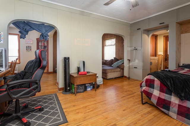 1311 Irving St, Alexandria, MN 56308 - home office with arched walkways, ornamental molding, ceiling fan, and light wood-style floors