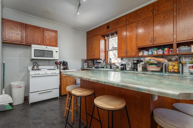 1311 Irving St, Alexandria, MN 56308 - kitchen featuring white appliances, brown cabinets, a sink, and light countertops