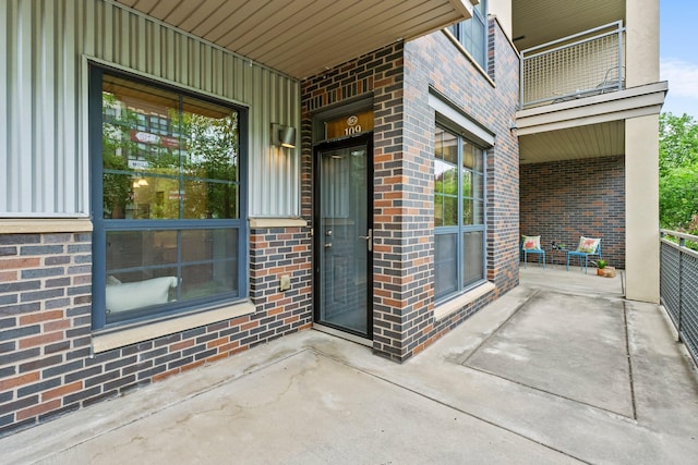 2565 Franklin Ave Unit 109, Saint Paul, MN 55114 - doorway to property featuring covered porch and brick siding