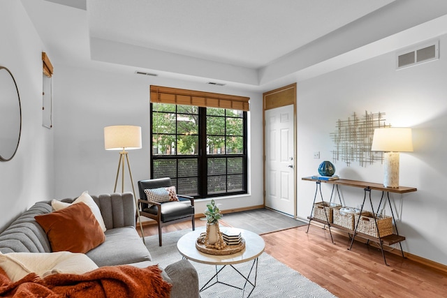 2565 Franklin Ave Unit 109, Saint Paul, MN 55114 - living area featuring a raised ceiling, wood finished floors, and baseboards