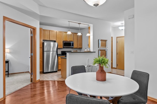 2565 Franklin Ave Unit 109, Saint Paul, MN 55114 - dining space featuring light wood-style flooring and baseboards
