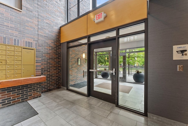 2565 Franklin Ave Unit 109, Saint Paul, MN 55114 - community lobby featuring a towering ceiling and brick wall