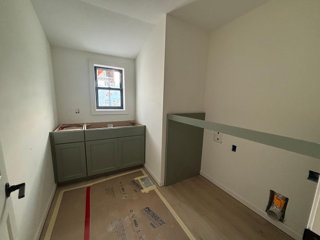 6200 Harkness Alcove S, Cottage Grove, MN 55016 - laundry area featuring light wood-style floors and baseboards