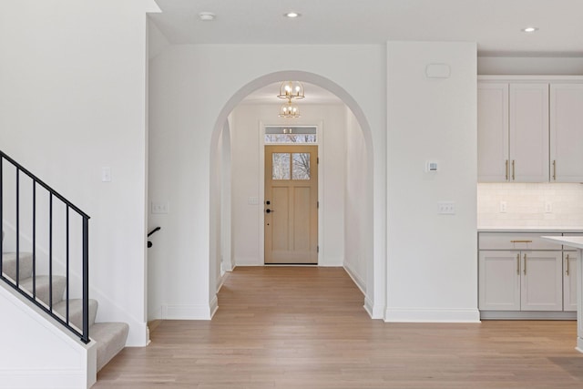 6200 Harkness Alcove S, Cottage Grove, MN 55016 - entryway featuring arched walkways, light wood-style flooring, stairway, recessed lighting, and a chandelier