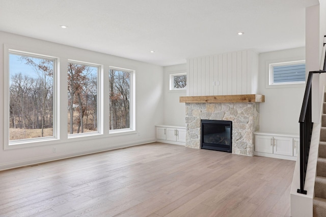 6200 Harkness Alcove S, Cottage Grove, MN 55016 - unfurnished living room with stairway, light wood finished floors, a stone fireplace, and recessed lighting