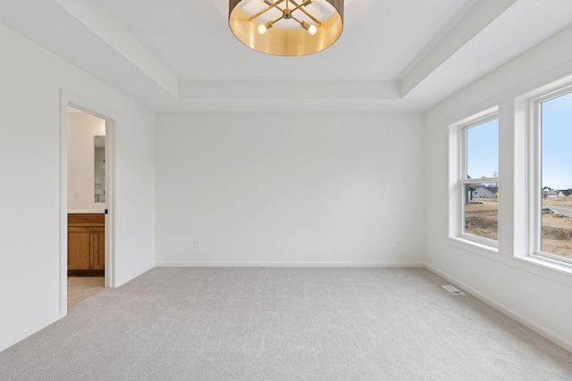 6200 Harkness Alcove S, Cottage Grove, MN 55016 - empty room with light colored carpet, a tray ceiling, and a chandelier