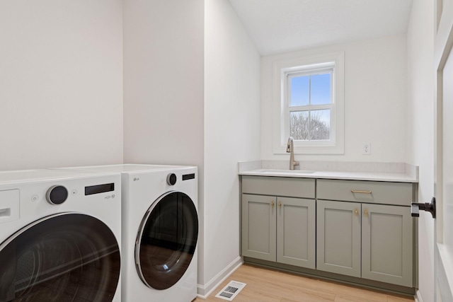 6200 Harkness Alcove S, Cottage Grove, MN 55016 - laundry room with independent washer and dryer, light wood-style flooring, and cabinet space
