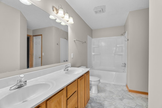bathroom with tub / shower combination, double vanity, toilet, and a sink