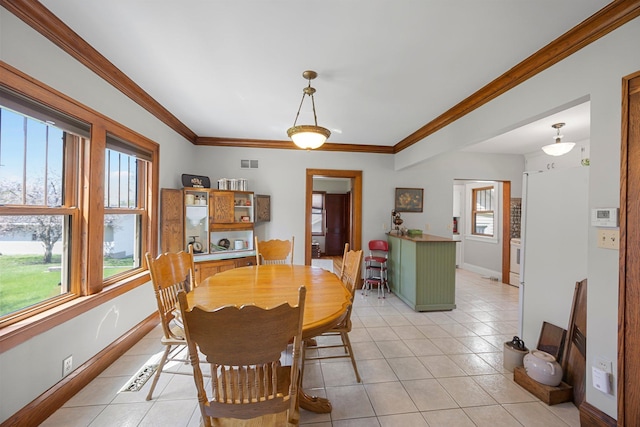 1114 6th St, Mankato, MN 56001 - dining space with plenty of natural light, light tile patterned floors, baseboards, and crown molding