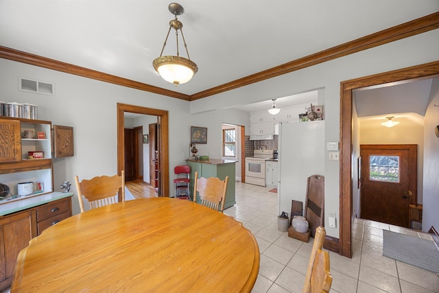 1114 6th St, Mankato, MN 56001 - dining space featuring light tile patterned floors, crown molding, and baseboards