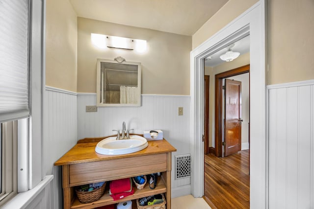 1114 6th St, Mankato, MN 56001 - bathroom with a wainscoted wall, wood finished floors, and vanity