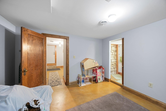 1114 6th St, Mankato, MN 56001 - bedroom with concrete flooring, baseboards, and ensuite bath