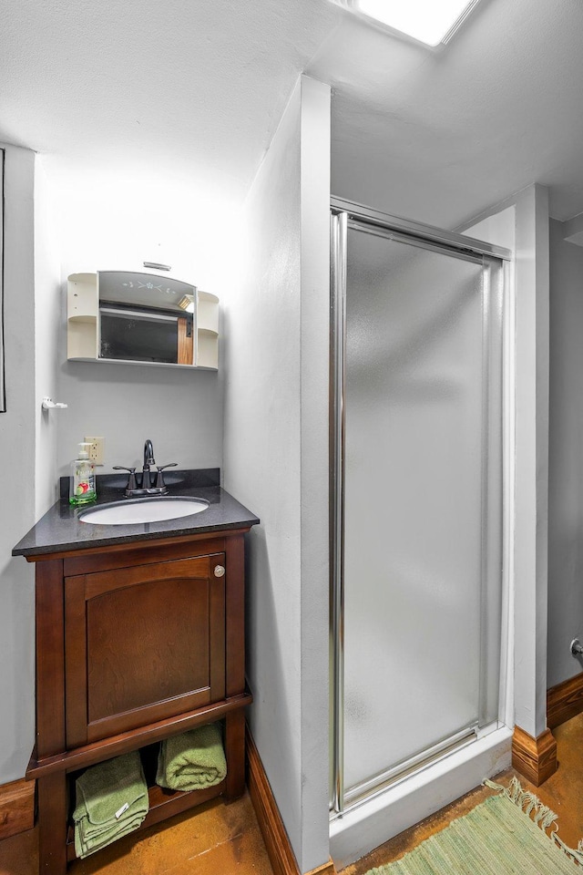 1114 6th St, Mankato, MN 56001 - bathroom with a shower stall, baseboards, and vanity